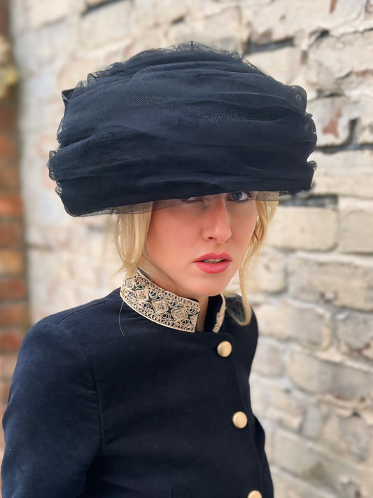 Irina   Tulle and silk in this wonderful vintage-inspired hat. It is held in place with a thin headband and a very fine elastic band for easy attachment.